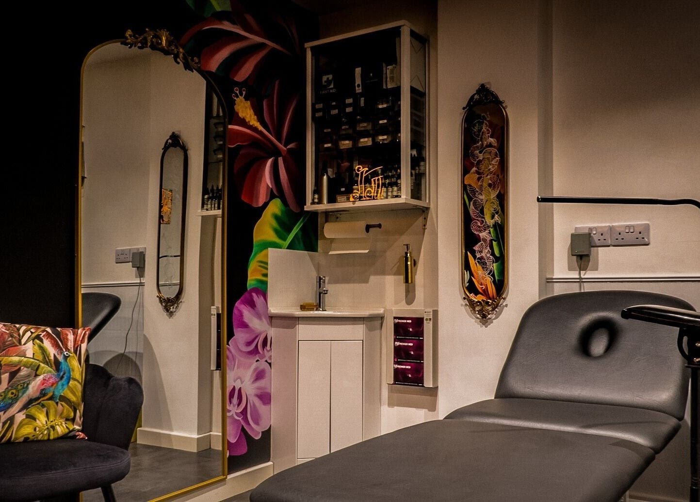 Stylish interior of Lucky Bird Tattoo Studio, Somerton, England, GB showcasing vibrant decor and tattoo chair.