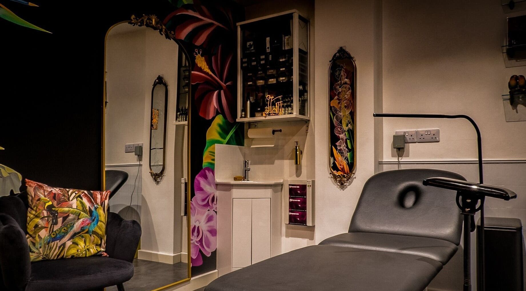 Stylish interior of Lucky Bird Tattoo Studio, Somerton, England, GB showcasing vibrant decor and tattoo chair.