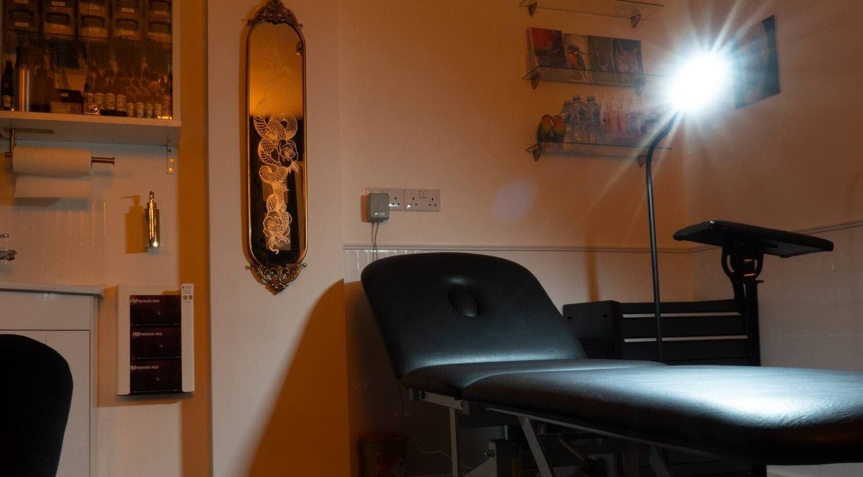 Cozy interior at Lucky Bird Tattoo Studio in Somerton, England, GB, showcasing a well-lit tattoo station.