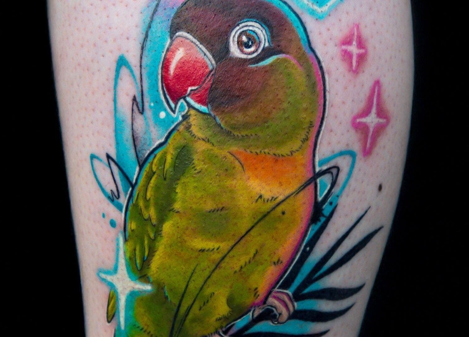 Colorful parrot tattoo at Lucky Bird Tattoo Studio in Somerton, England, GB, showcasing vibrant artistry.