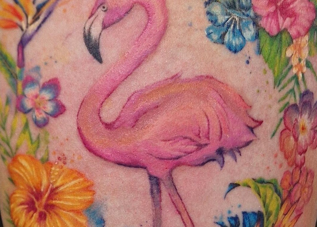 Colorful flamingo tattoo at Lucky Bird Tattoo Studio in Somerton, England, GB, showcasing floral details.