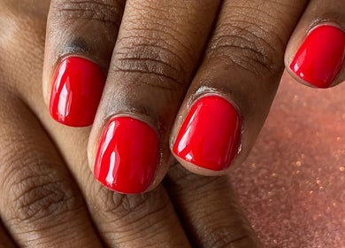Bright red manicured nails at Palangana Spa, Willemstad, Curaçao, CW, showcasing elegance and care.