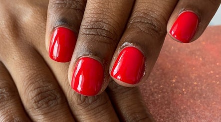 Bright red manicured nails at Palangana Spa, Willemstad, Curaçao, CW, showcasing elegance and care.