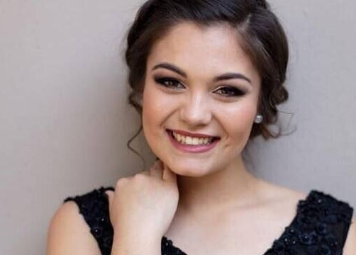 Smiling woman with elegant hairstyle at Mooi Nooi Haarsalon in Bloemfontein, Freestate, ZA.