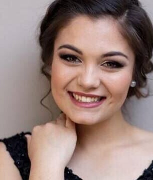 Smiling woman with elegant hairstyle at Mooi Nooi Haarsalon in Bloemfontein, Freestate, ZA.