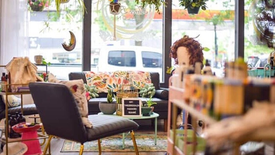 Cozy interior of Three Birds Salon in Orillia, Ontario, CA with vibrant decor and seating area.