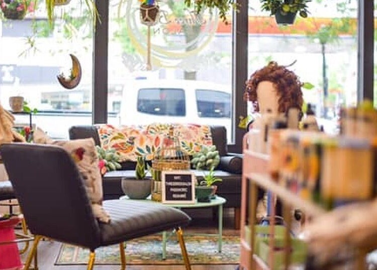 Cozy interior of Three Birds Salon in Orillia, Ontario, CA with vibrant decor and seating area.