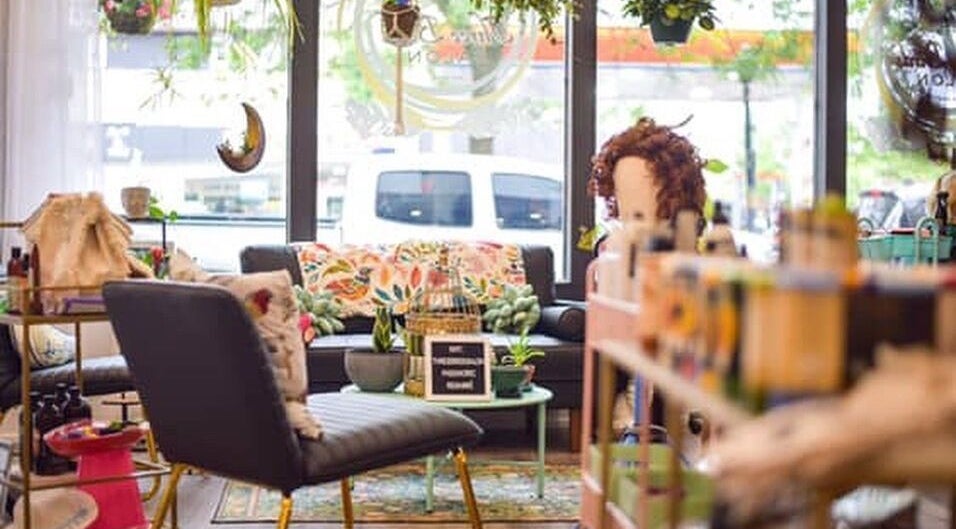 Cozy interior of Three Birds Salon in Orillia, Ontario, CA with vibrant decor and seating area.