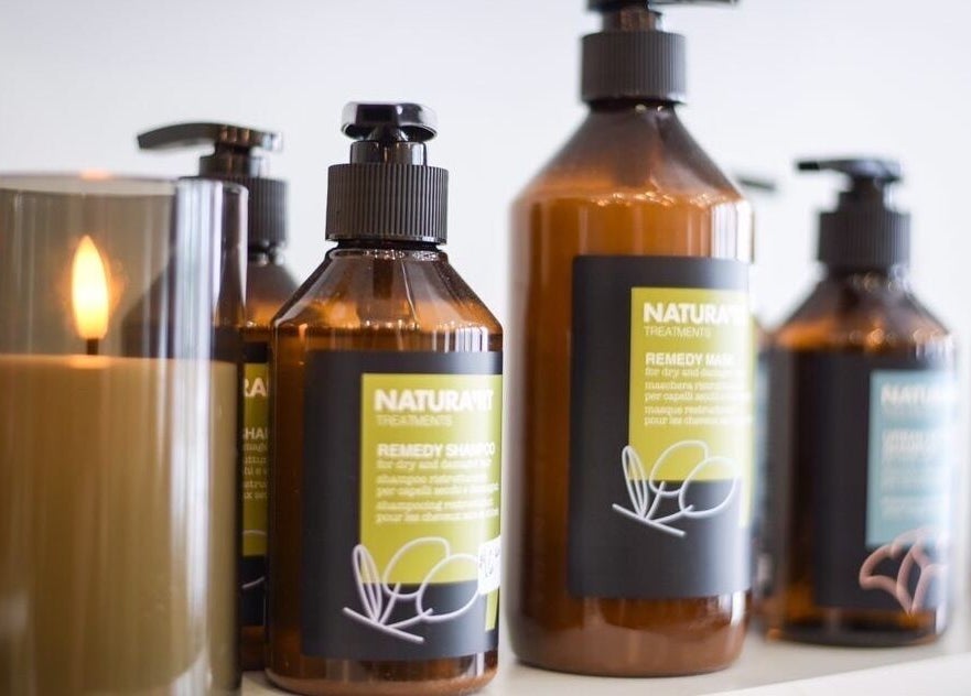 Elegant product display with candle at Three Birds Salon, Orillia, Ontario, CA, enhancing the tranquil atmosphere.