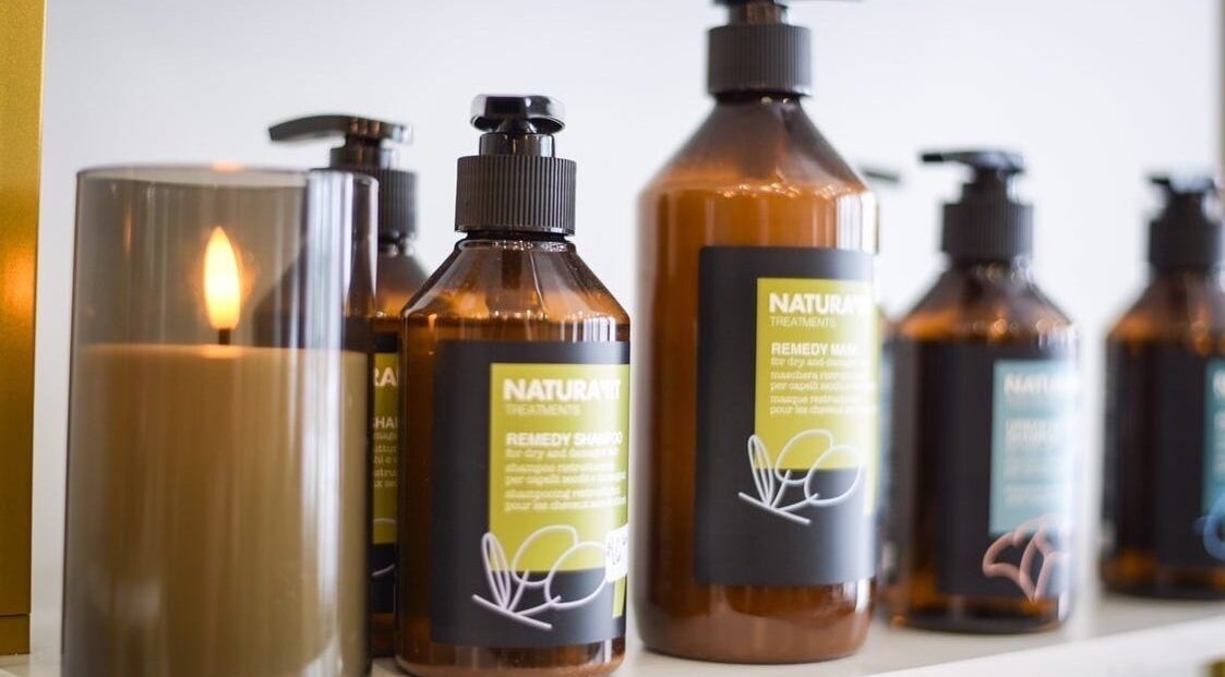 Elegant product display with candle at Three Birds Salon, Orillia, Ontario, CA, enhancing the tranquil atmosphere.