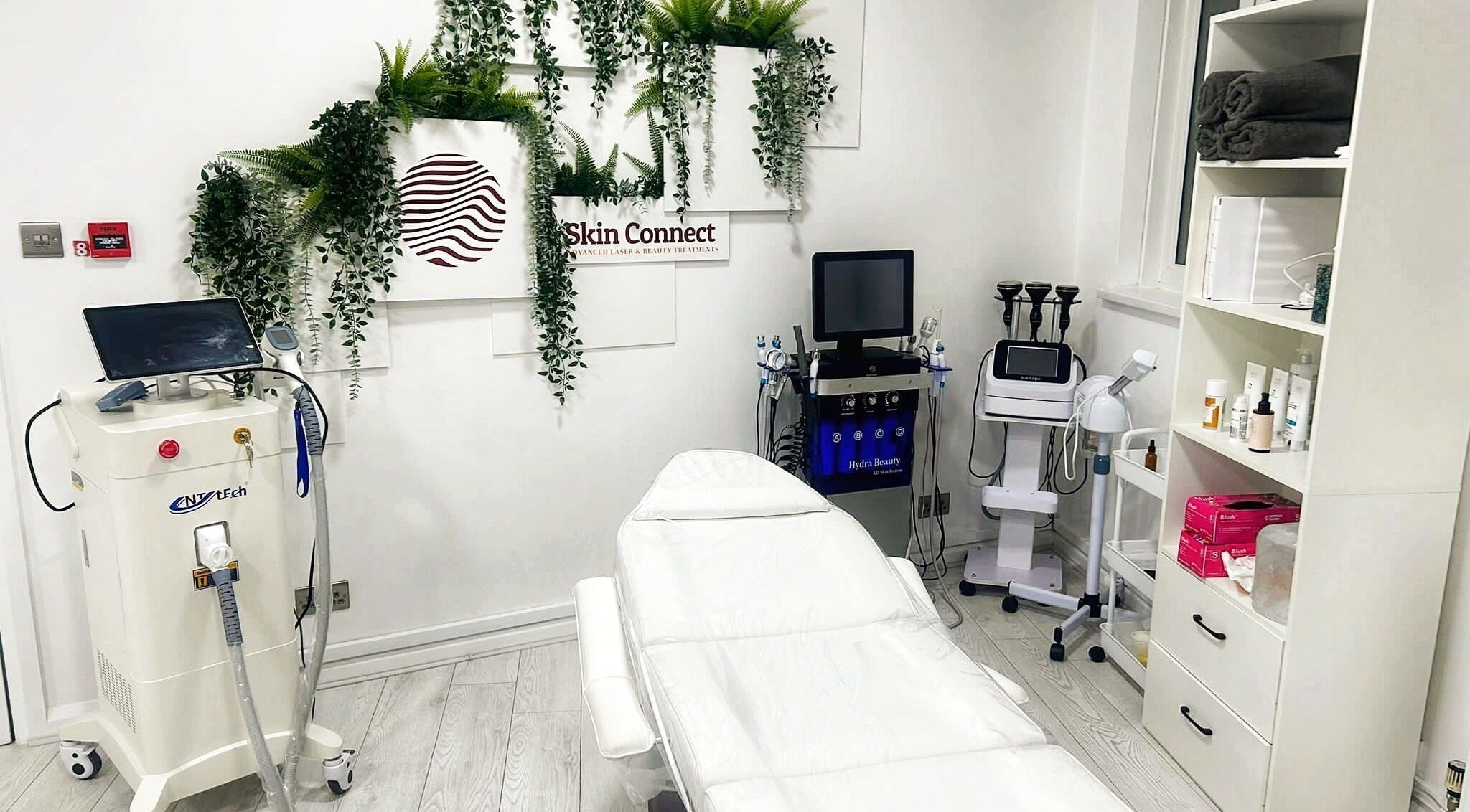 Cosmederm Clinic - Dr Aryan in Birmingham, England, GB offers a serene treatment room with modern equipment and greenery.