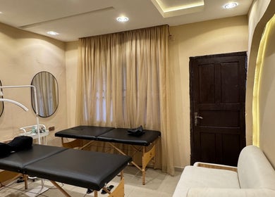 Relaxing treatment room at The Villa Spa, Awka, Anambra, NG, featuring massage tables and calming decor.