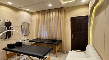 Relaxing treatment room at The Villa Spa, Awka, Anambra, NG, featuring massage tables and calming decor.