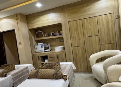 Cozy treatment room at The Villa Spa, Awka, Anambra, NG with plush seating and wooden cabinetry.