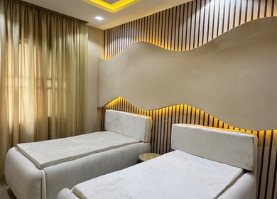 Elegant spa room with twin beds at The Villa Spa, Awka, Anambra, NG, featuring soft lighting and soothing decor.