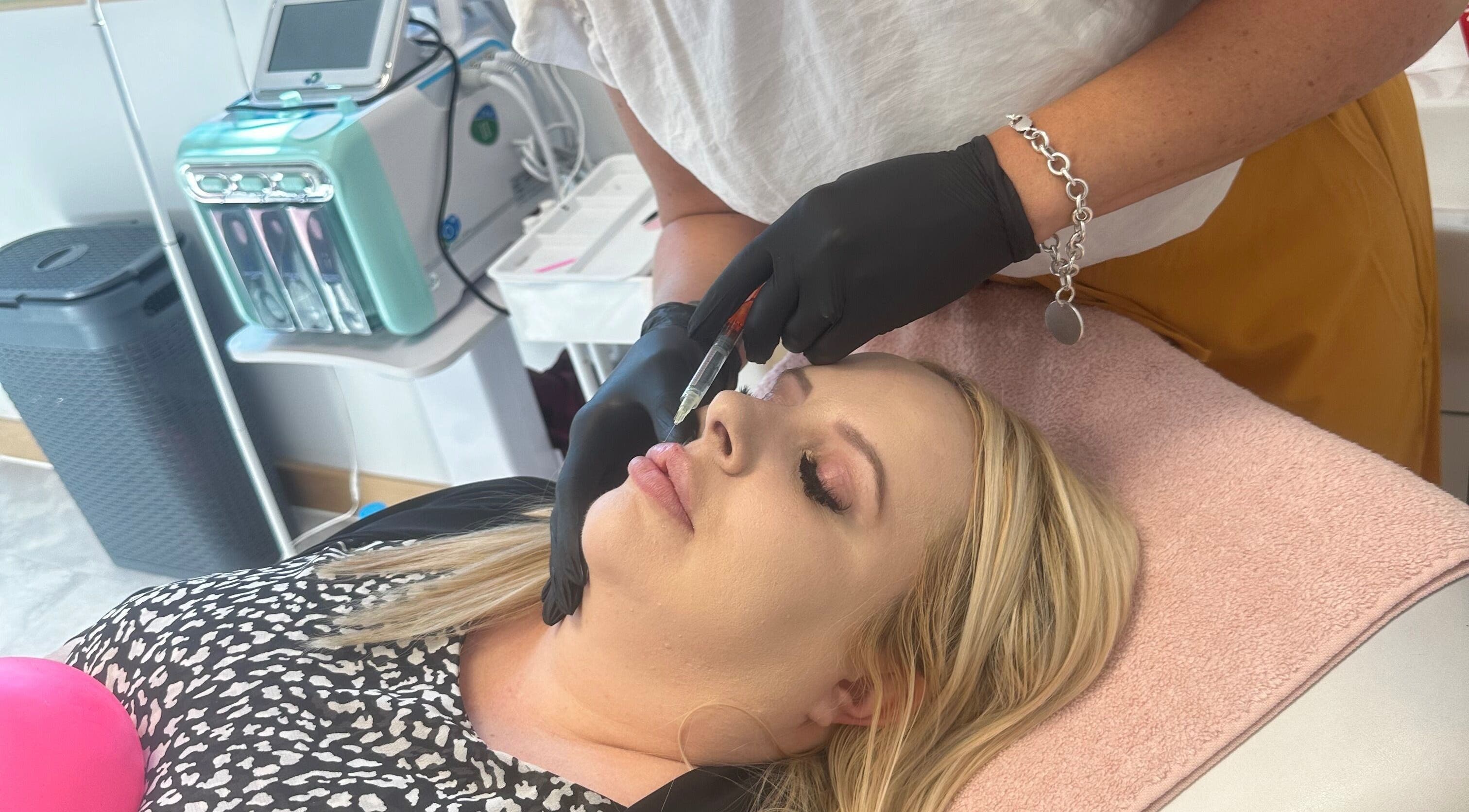 Lip enhancement procedure at Barbara Sue Aesthetics Ltd, Felixstowe, England, GB. Aesthetician administering treatment.