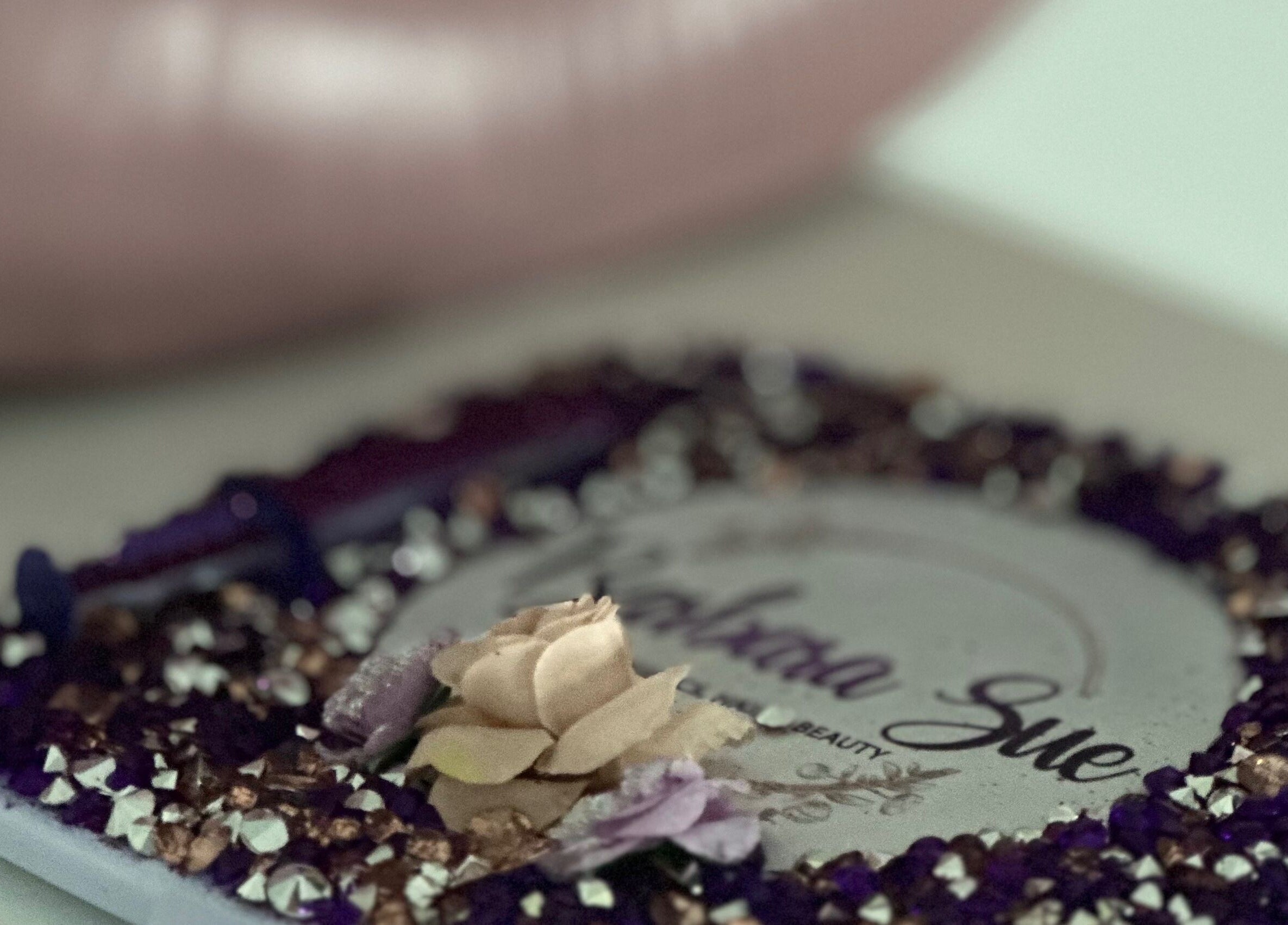 Decorative plate with floral and gem design at Barbara Sue Aesthetics Ltd, Felixstowe, England, GB.