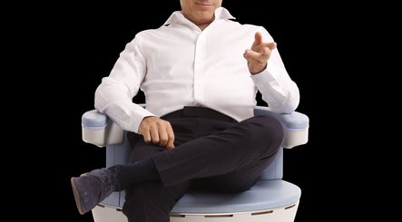 Man sitting on a wellness chair at Current Body Solutions/Concierge Functional Wellness LLC in Houston, Texas, US.