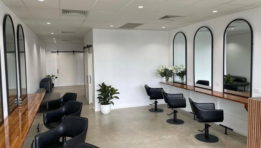 Modern salon interior with sleek mirrors and chairs at Mane Haus, Melbourne, Victoria, AU.