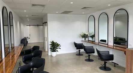 Modern salon interior with sleek mirrors and chairs at Mane Haus, Melbourne, Victoria, AU.
