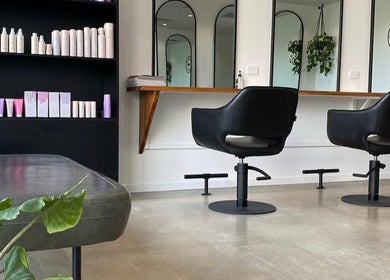 Elegant salon chairs and mirrors at Mane Haus, Melbourne, Victoria, AU showcasing a modern aesthetic.