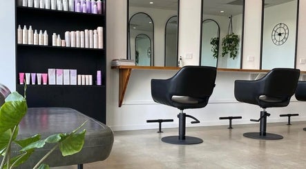 Modern salon interior at Mane Haus, Melbourne, Victoria, AU with stylish chairs and product display.