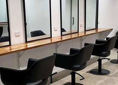 Mane Haus salon chairs and mirrors in Melbourne, Victoria, AU, offering a modern and chic atmosphere.