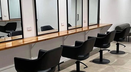 Mane Haus salon chairs and mirrors in Melbourne, Victoria, AU, offering a modern and chic atmosphere.