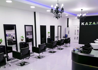 Chic styling area at Kazanoo Hair Studio by Adrian, Galway, County Galway, IE featuring modern black chairs.