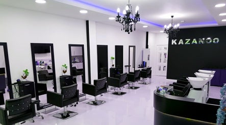 Chic styling area at Kazanoo Hair Studio by Adrian, Galway, County Galway, IE featuring modern black chairs.