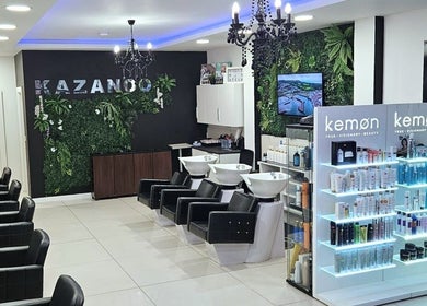 Modern interior of Kazanoo Hair By Adrian, Galway, County Galway, IE, featuring sleek chairs and vibrant displays.