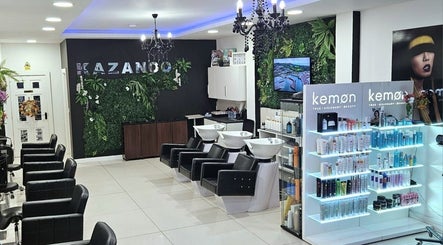 Modern interior of Kazanoo Hair By Adrian, Galway, County Galway, IE, featuring sleek chairs and vibrant displays.