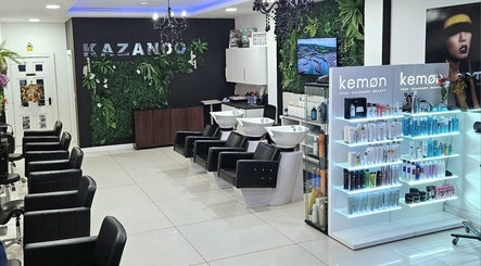 Kazanoo Hair By Adrian salon in Galway, County Galway, IE, featuring modern chairs and a lush plant wall.