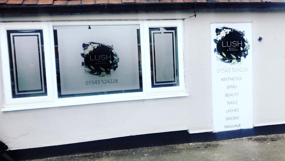 Front window of Lush Beauty and Massage in Heath Hayes, England, GB showcasing logo and services.