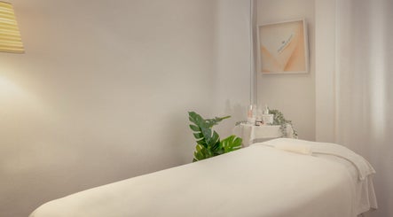 Relaxing treatment room at Pure Tincture Organic Beauty - Adelphi, Singapore, Singapore, SG with lush greenery.