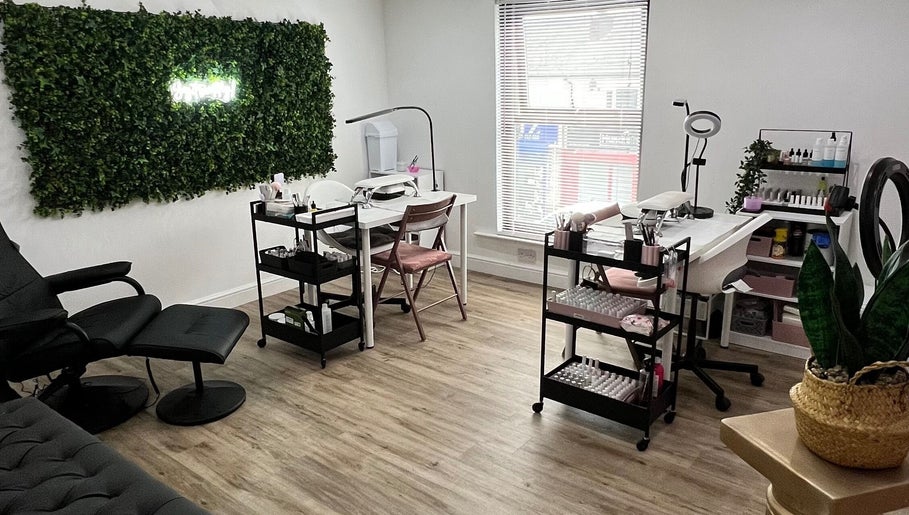 Charlotte Marie MUA & Nails in Farnworth, England, GB featuring a chic nail salon setup with greenery wall decor.