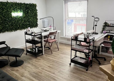 Charlotte Marie MUA & Nails in Farnworth, England, GB featuring a chic nail salon setup with greenery wall decor.