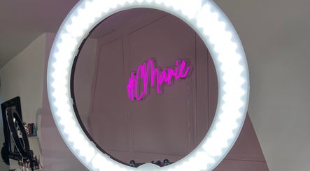 Ring light illuminating Charlotte Marie MUA & Nails neon sign in Farnworth, England, GB.