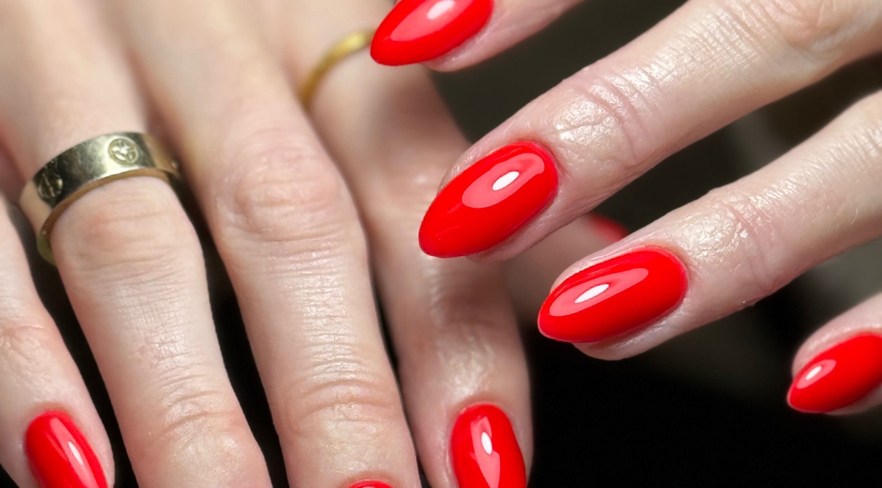 Vibrant red manicured nails at RD Artistry in Mansfield, England, GB, showcasing elegant style.
