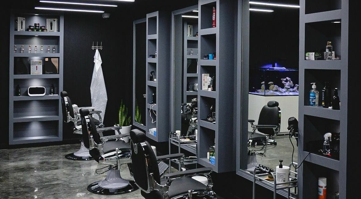 Elegant interior of Perfect Home Gents Center in Sharjah, AE showcasing modern barber chairs and shelves.