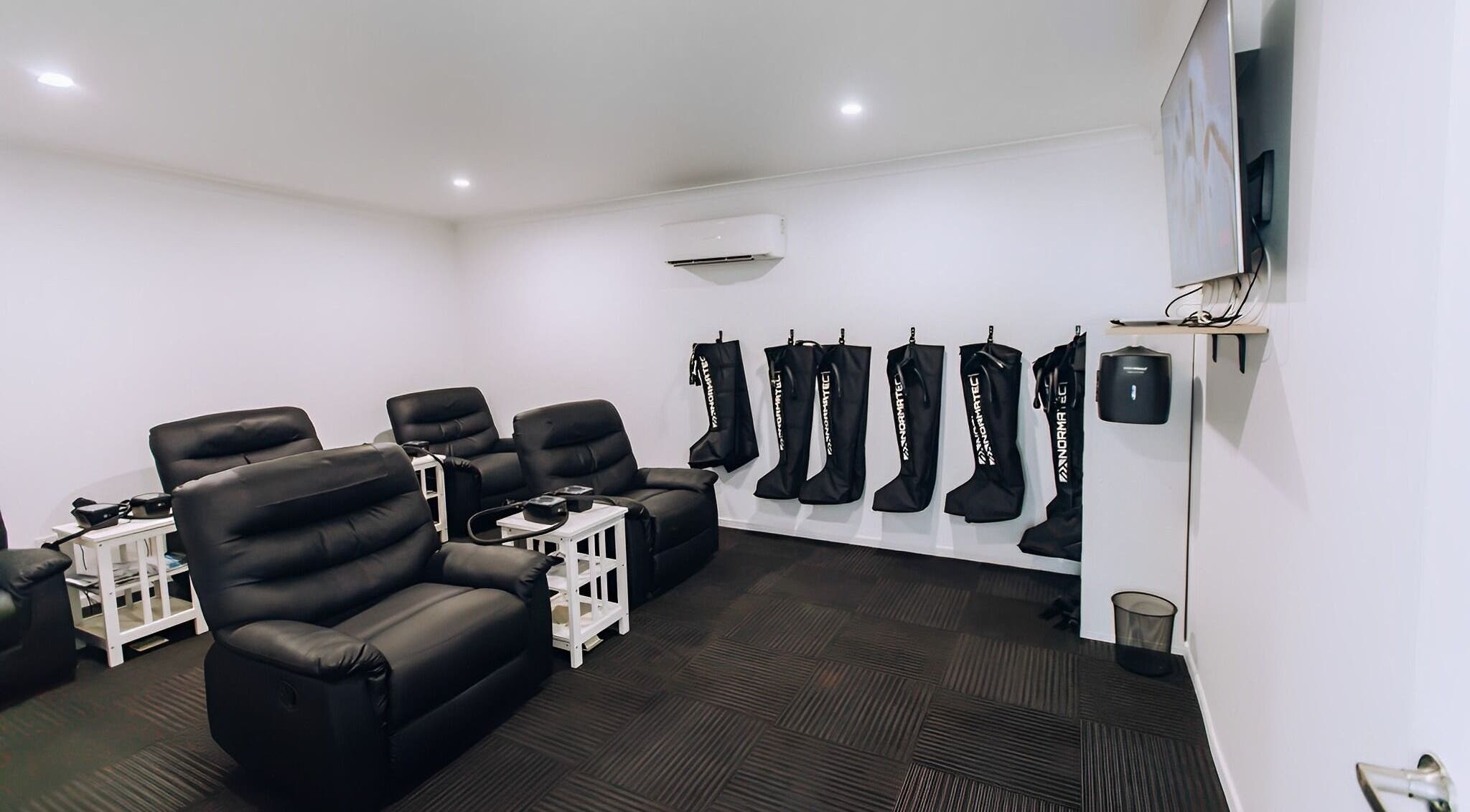 TLC Recovery's cozy lounge with recliners and wellness equipment in Alexandra Headland, Queensland, AU.