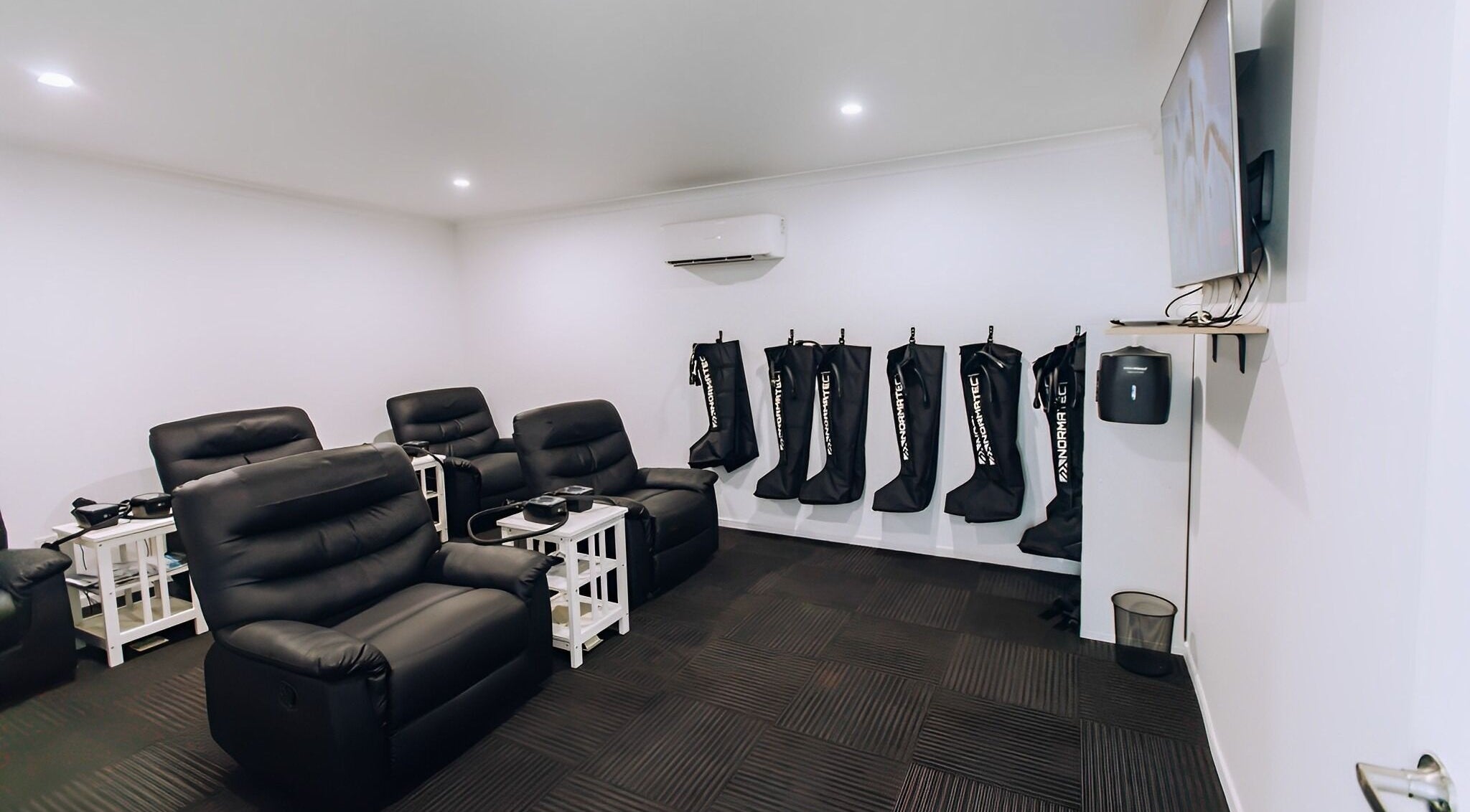 TLC Recovery's cozy lounge with recliners and wellness equipment in Alexandra Headland, Queensland, AU.