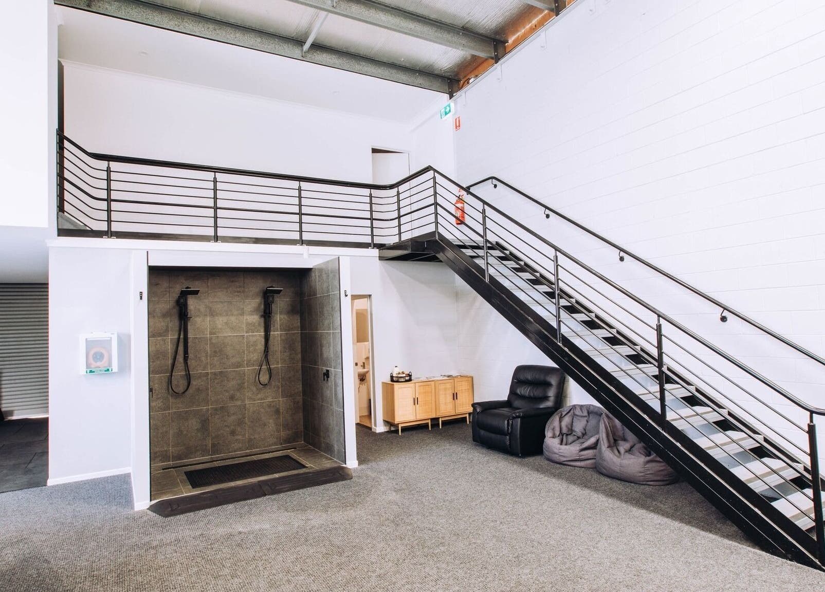Spacious relaxation area at TLC Recovery, Alexandra Headland, Queensland, AU with sleek interior and cozy seating.