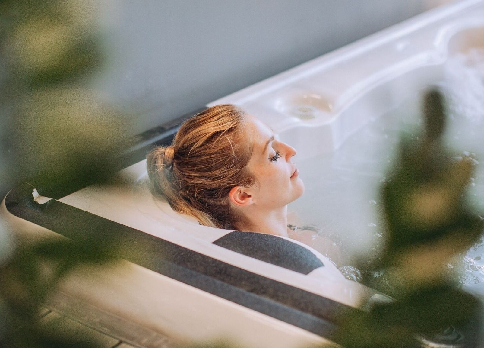 Woman relaxing in a spa bath at TLC Recovery, Alexandra Headland, Queensland, AU.