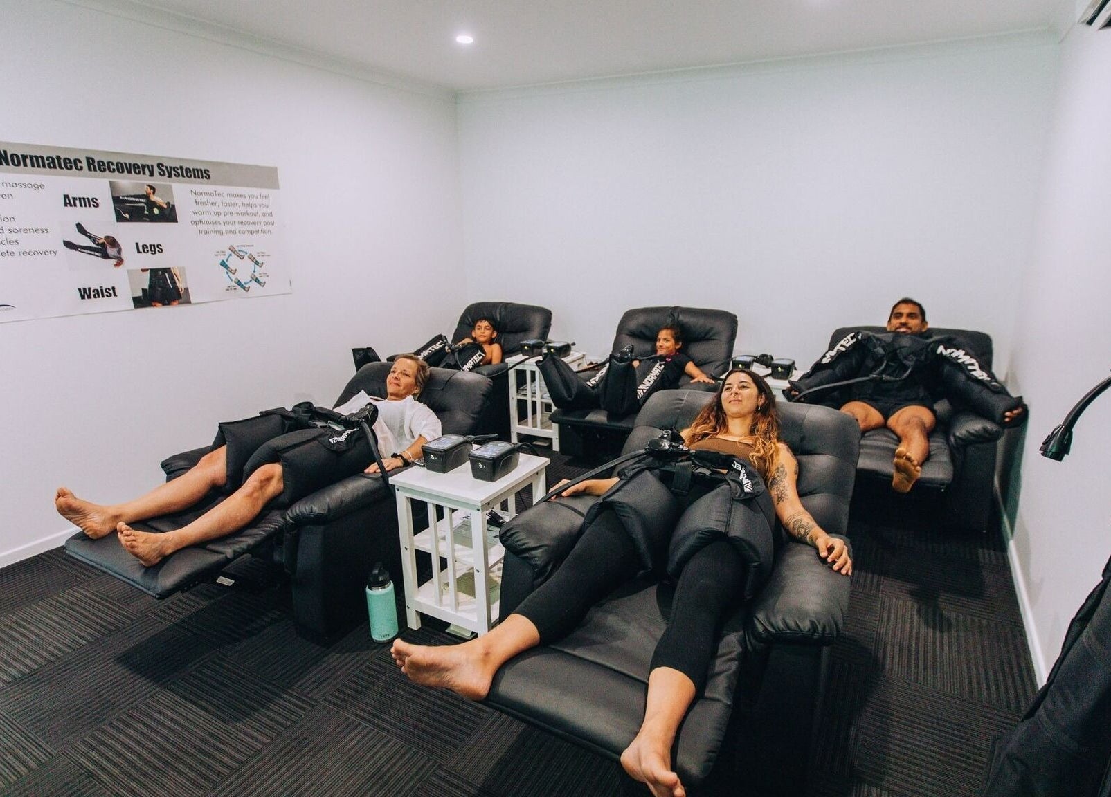 Guests enjoying recovery therapy at TLC Recovery, Alexandra Headland, Queensland, AU in comfortable lounge chairs.