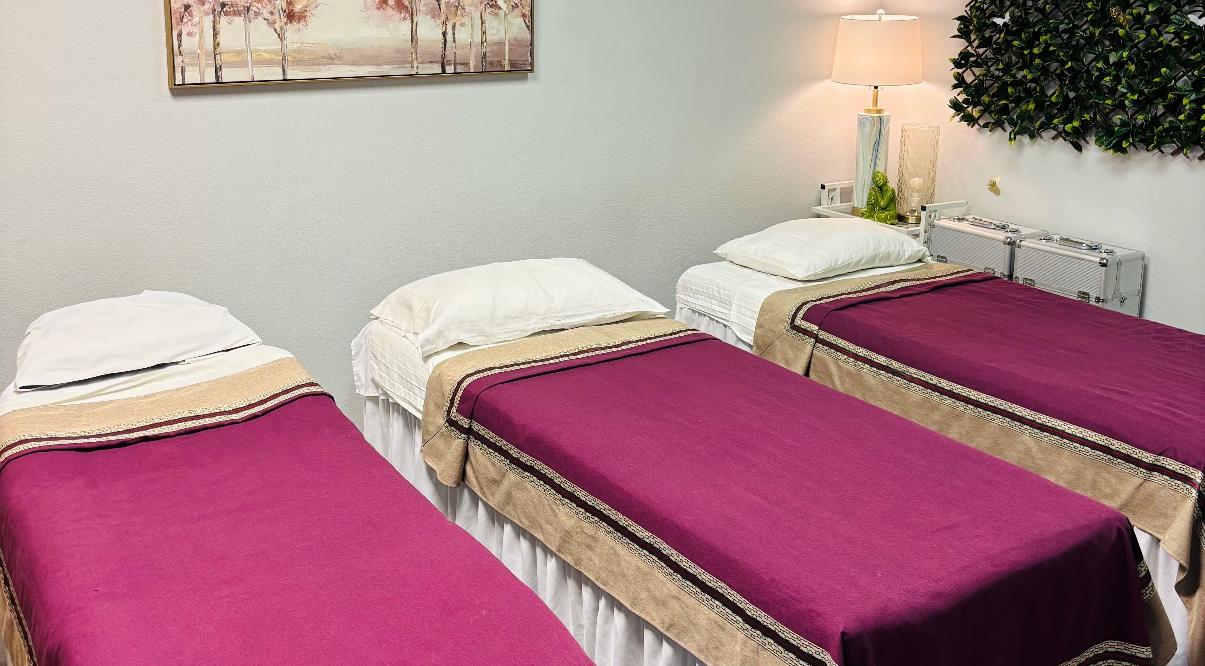 Three massage beds with purple covers at LUXE Thai Spa & Massage, Las Vegas, Nevada, US.