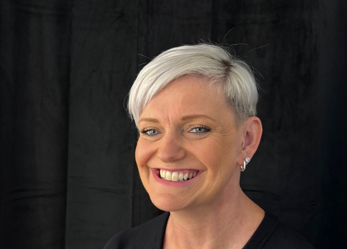 A smiling client with short hair at Stephanie Clark in Winkfield, GB, showcasing expert styling.