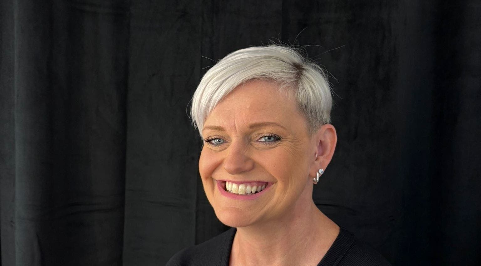 A smiling client with short hair at Stephanie Clark in Winkfield, GB, showcasing expert styling.