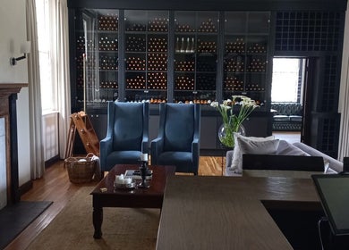Elegant lounge at House of Beauty and Skincare in Grabouw, Western Cape, ZA, featuring plush chairs and a cozy fireplace.