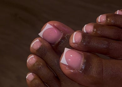 Beautiful French pedicure at That Girl Collection, Ajax, CA, showcasing pristine nail art on toes.